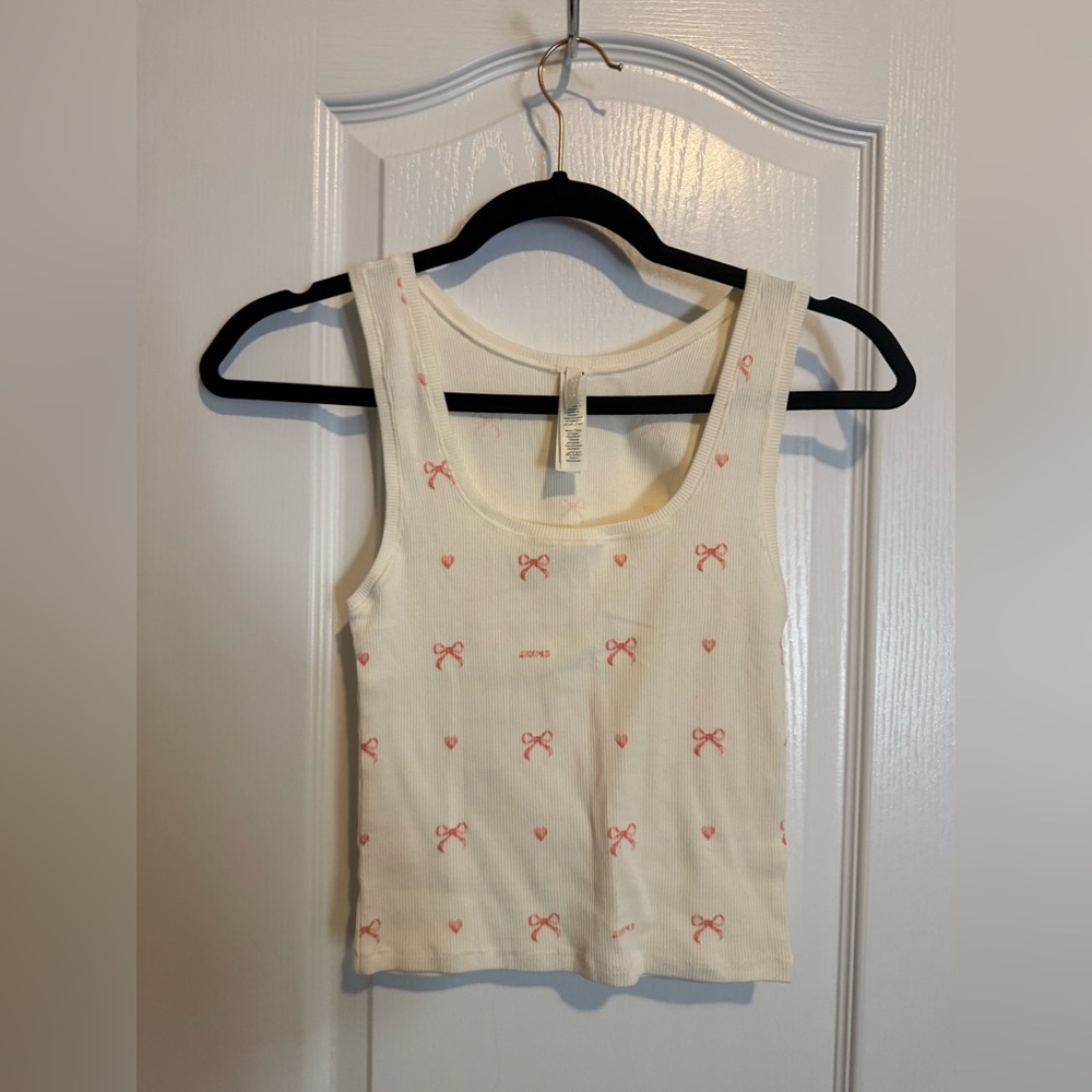 SKIMS Cream Ribbed Top with pink bows and hearts